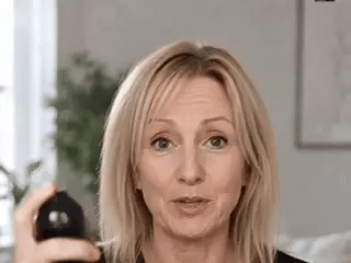 Applying the volumizing mist and gently lifting the roots